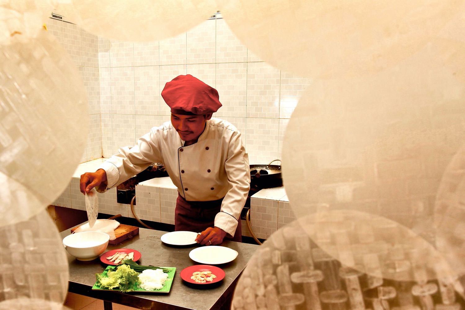 a chef framed by rice paper