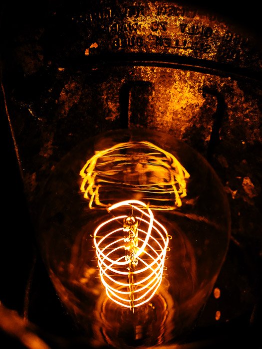 smartphone product shot of a lightbulb on dark background